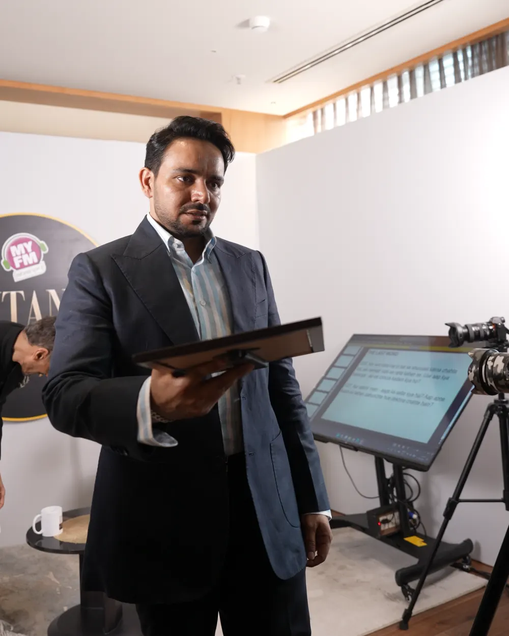 Amrit Deol holding the Titans of Punjab plaque